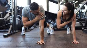 Image of man and woman doing Cardio Deal to tone their arms. 
